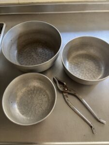 取っ手のないやっとこ鍋3つと、やっとこの道具
